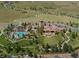 Aerial view of community clubhouse with outdoor pool, walking paths, amphitheater, and surrounding green space at 2130 S Poppy St, Lakewood, CO 80228