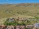 Breathtaking aerial view of community clubhouse, pool, and surrounding landscape nestled amidst rolling hills at 2130 S Poppy St, Lakewood, CO 80228