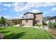 Spacious backyard featuring a lush lawn and an outdoor stone grill area, perfect for entertaining at 2130 S Poppy St, Lakewood, CO 80228