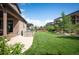 A well-kept lawn and landscaping complement the patio and grill area in this backyard at 2130 S Poppy St, Lakewood, CO 80228