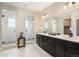 This bathroom has dual sinks, a dark vanity, a large mirror, and two glass-enclosed showers at 2130 S Poppy St, Lakewood, CO 80228