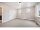 The bedroom features neutral carpet, white trim, ample lighting, and a closet with sliding doors at 2130 S Poppy St, Lakewood, CO 80228