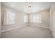 This bedroom features neutral carpet, white trim, ample lighting, and multiple windows with blinds at 2130 S Poppy St, Lakewood, CO 80228