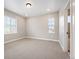 This bedroom features neutral carpet, white trim, ample lighting, and multiple windows with blinds at 2130 S Poppy St, Lakewood, CO 80228