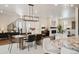 Bright, open-concept space with hardwood floors, a modern chandelier, and a cozy fireplace at 2130 S Poppy St, Lakewood, CO 80228