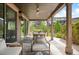 Covered patio featuring comfortable furniture, ceiling fan, and dining area with backyard views at 2130 S Poppy St, Lakewood, CO 80228