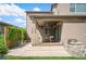 Covered patio features outdoor dining, grill, lush climbing vegetation, and seamless indoor-outdoor flow at 2130 S Poppy St, Lakewood, CO 80228