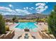 Resort-style community pool with mountain views, lounge chairs, and a serene environment at 2130 S Poppy St, Lakewood, CO 80228
