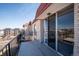Outdoor balcony with iron railing and views of the nearby neighborhood and building at 7801 W 35Th Ave # 405, Wheat Ridge, CO 80033