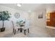 Bright dining room with a round glass table, soft chairs, and a large clock as a focal point at 7801 W 35Th Ave # 405, Wheat Ridge, CO 80033