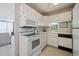 Efficient kitchen with a white refrigerator, microwave, range, and cabinetry for a clean, organized look at 7801 W 35Th Ave # 405, Wheat Ridge, CO 80033