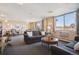Open concept living room featuring comfortable sofas, carpet, and large windows at 7801 W 35Th Ave # 405, Wheat Ridge, CO 80033