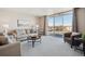Bright living room with large glass doors to balcony and views of the surrounding area at 7801 W 35Th Ave # 405, Wheat Ridge, CO 80033