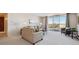 Sunny living room with a comfortable sofa, side tables, a balcony with views, and a cozy atmosphere at 7801 W 35Th Ave # 405, Wheat Ridge, CO 80033