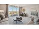 Open-plan living room featuring plush neutral furniture and a large window to a balcony at 7801 W 35Th Ave # 405, Wheat Ridge, CO 80033