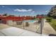 Community pool area featuring lounge chairs and tables with umbrellas for residents' enjoyment at 7801 W 35Th Ave # 405, Wheat Ridge, CO 80033