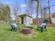 Landscaped backyard with Adirondack chairs around a fire pit at 7160 W 24Th Ave, Lakewood, CO 80214