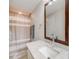 Bathroom featuring a vanity with granite countertops, a mirror, and a shower with a curtain at 7160 W 24Th Ave, Lakewood, CO 80214