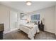 Bedroom with neutral tones, a cozy bed, and a window with natural light at 7160 W 24Th Ave, Lakewood, CO 80214