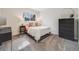 Bedroom with a comfortable bed, dresser, and a window with natural light at 7160 W 24Th Ave, Lakewood, CO 80214