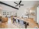 Open-concept dining room with a modern table and chairs, seamlessly connected to the living room and kitchen at 7160 W 24Th Ave, Lakewood, CO 80214