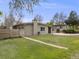 Well-maintained single-story home featuring a lush, green lawn and fenced yard at 7160 W 24Th Ave, Lakewood, CO 80214