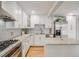 Bright kitchen with stainless steel appliances, white cabinets, and granite countertops at 7160 W 24Th Ave, Lakewood, CO 80214