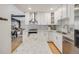 Modern kitchen featuring white cabinets, stainless steel appliances, and a granite countertop island at 7160 W 24Th Ave, Lakewood, CO 80214