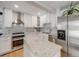 Bright kitchen with stainless steel appliances, white cabinets, and granite countertops at 7160 W 24Th Ave, Lakewood, CO 80214