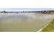 Expansive view of a calm lake with lush vegetation and grass along the shoreline at 7160 W 24Th Ave, Lakewood, CO 80214