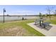 Scenic picnic area with a table overlooking a tranquil lake, perfect for outdoor gatherings at 7160 W 24Th Ave, Lakewood, CO 80214