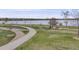 Picturesque walking path by a serene lake, surrounded by lush greenery and mature trees at 7160 W 24Th Ave, Lakewood, CO 80214
