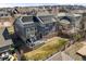 Aerial view of a home with solar panels, a deck, a yard, and a surrounding neighborhood at 26890 E Roxbury Pl, Aurora, CO 80016