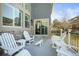 Back deck with outdoor seating, overlooking backyard landscaping and a sliding glass door entrance at 26890 E Roxbury Pl, Aurora, CO 80016