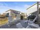 Outdoor deck with white Adirondack chairs, tables and a grill, perfect for entertaining guests at 26890 E Roxbury Pl, Aurora, CO 80016
