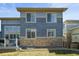 Back exterior with stone accents, well-kept lawn, and nice window views at 26890 E Roxbury Pl, Aurora, CO 80016
