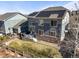 Back exterior of a two-story home with solar panels, a deck, and a fenced yard at 26890 E Roxbury Pl, Aurora, CO 80016