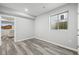Basement with gray wood floors and window with view to the outside at 26890 E Roxbury Pl, Aurora, CO 80016