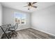 This bedroom features natural light, laminate floors, and neutral tones at 26890 E Roxbury Pl, Aurora, CO 80016