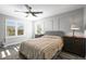Bedroom features two windows with shutters, a ceiling fan, and a comfortable bed at 26890 E Roxbury Pl, Aurora, CO 80016
