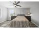 Bedroom features two windows with shutters, a ceiling fan, and neutral paint at 26890 E Roxbury Pl, Aurora, CO 80016
