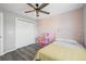 This bedroom offers ample closet space, ceiling fan, and soft pink walls at 26890 E Roxbury Pl, Aurora, CO 80016