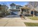 Charming two-story home features a covered front porch and well-maintained landscaping at 26890 E Roxbury Pl, Aurora, CO 80016