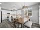Modern eat-in kitchen with white cabinets, granite counters, stainless steel appliances, pendant lighting, and plank flooring at 26890 E Roxbury Pl, Aurora, CO 80016