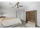 This main bedroom offers a ceiling fan and a wardrobe with modern grey floors at 26890 E Roxbury Pl, Aurora, CO 80016