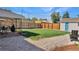 Backyard features a well-maintained lawn, gravel area, patio with dining set, and a detached garage at 771 S Dale Ct, Denver, CO 80219