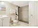 Bathroom with a stylish stand-up shower featuring black pebble flooring and geometric shower curtain at 771 S Dale Ct, Denver, CO 80219