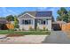 Gray home featuring solar panels, blue shutters, and a newly planted front yard tree at 771 S Dale Ct, Denver, CO 80219