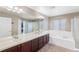 Double vanity bathroom with soaking tub at 21093 E Hampden Pl, Aurora, CO 80013