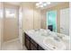 Clean bathroom with double vanity and plenty of counter space at 21093 E Hampden Pl, Aurora, CO 80013